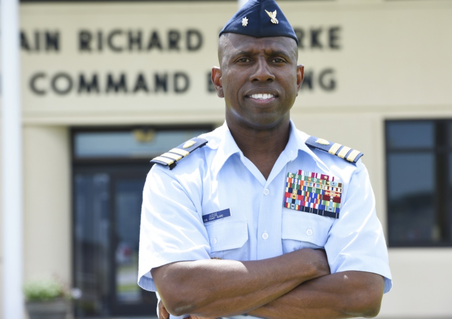 Coast Guard Cmdr. Warren Judge, executive officer of Base Elizabeth City, North Carolina, poses for a photograph outside the command building on base, Aug. 10, 2017. Judge was selected as the 2017 Blacks in Government Meritorious Service Award recipient for his volunteer work with local youth organizations and his role in solidifying a memorandum of agreement between the base and Elizabeth City State University. (U.S. Coast Guard photo by Petty Officer 3rd Class Corinne Zilnicki/Released)