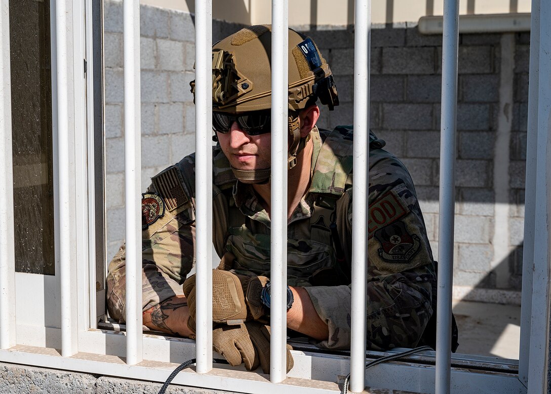 U.S. Air Force Staff Sgt. Ryan Melody, 380th Expeditionary Civil Engineer Squadron explosive ordnance disposal (EOD) technician, examines a room containing a simulated explosive during a joint training event at Al Dhafra Air Base, United Arab Emirates, Jan. 28, 2021.