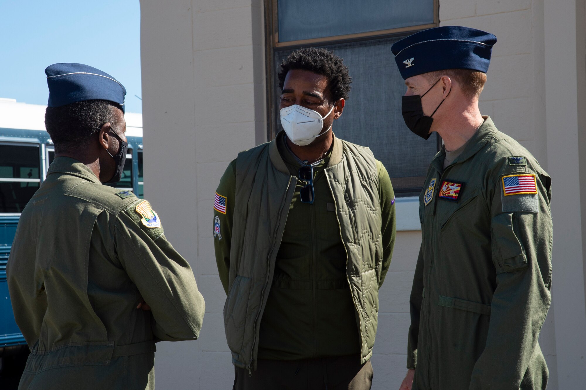 U.S. Air Force Col. Ben Jonsson, the 6th Air Refueling Wing (ARW) commander and Col. Travis Edwards, 6th Operations Group commander greet NFL Hall of Famer Cris Carter during an NFL media tour at MacDill Air Force Base, Fla. Feb. 4, 2021.