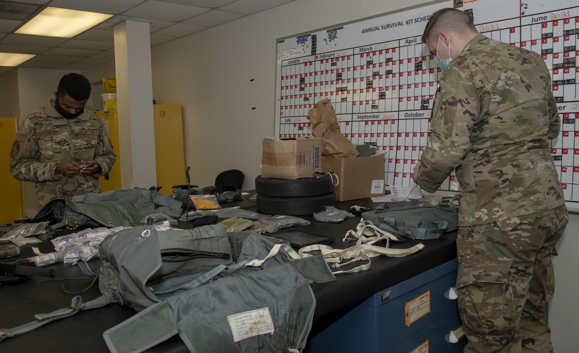 Photo of Airmen packing survival kits.