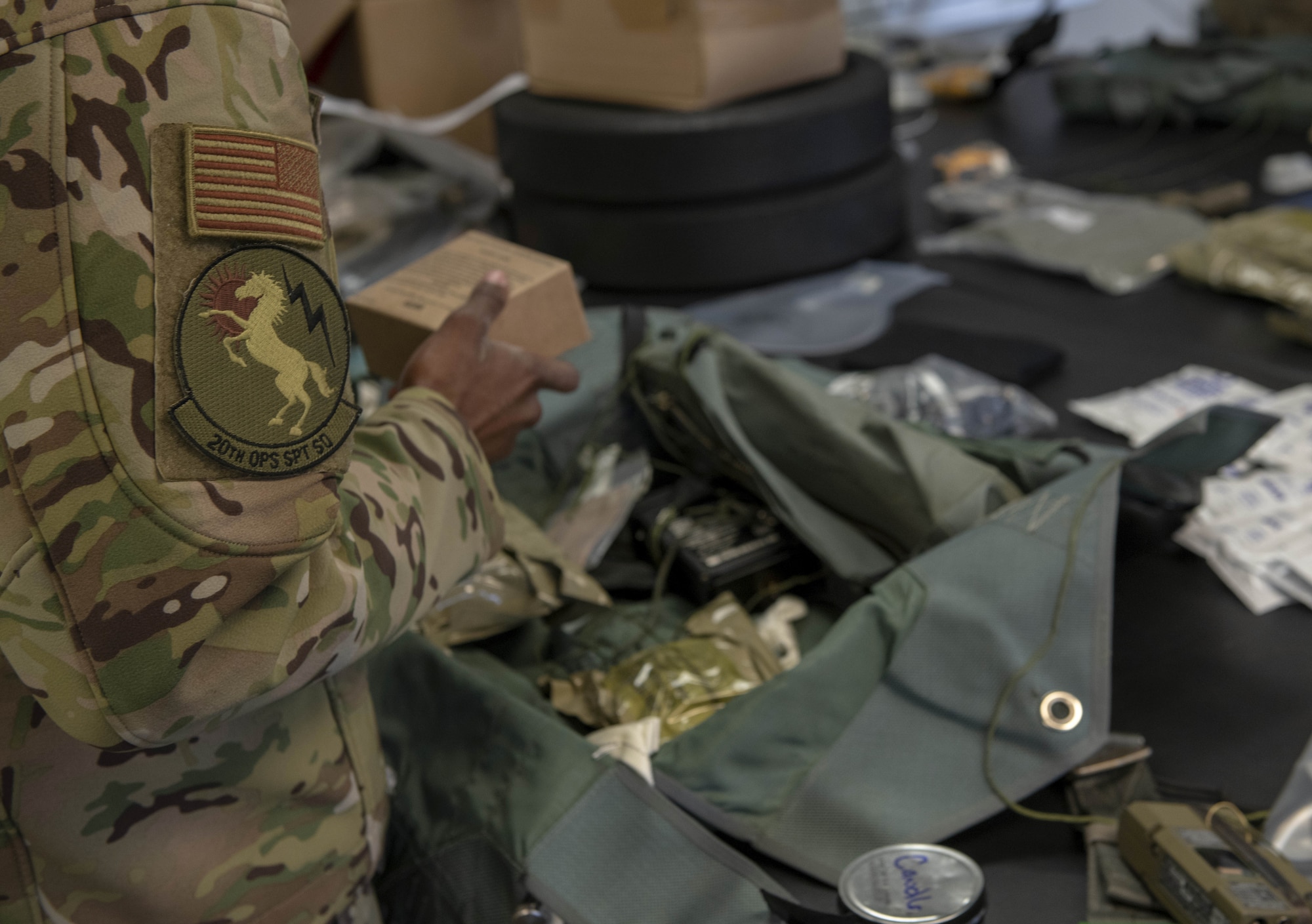 Photo of Airman packing survival kit.