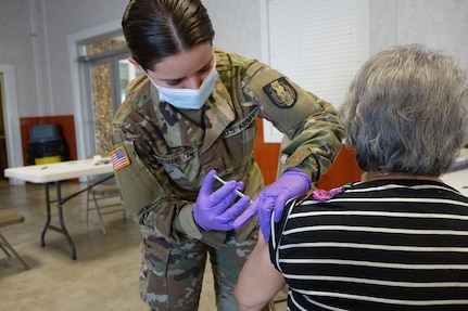 Texas National Guard medics join first responders from DeWitt County, Texas A&M AgriLife and the TexasDepartment of Emergency Management (TDEM) at a mobile vaccination event, Jan. 29, 2021, in Cuero, Texas. The event was part of a state effort to vaccinate Texans living in underserved  communities who are considered to be high-risk for COVID-19.