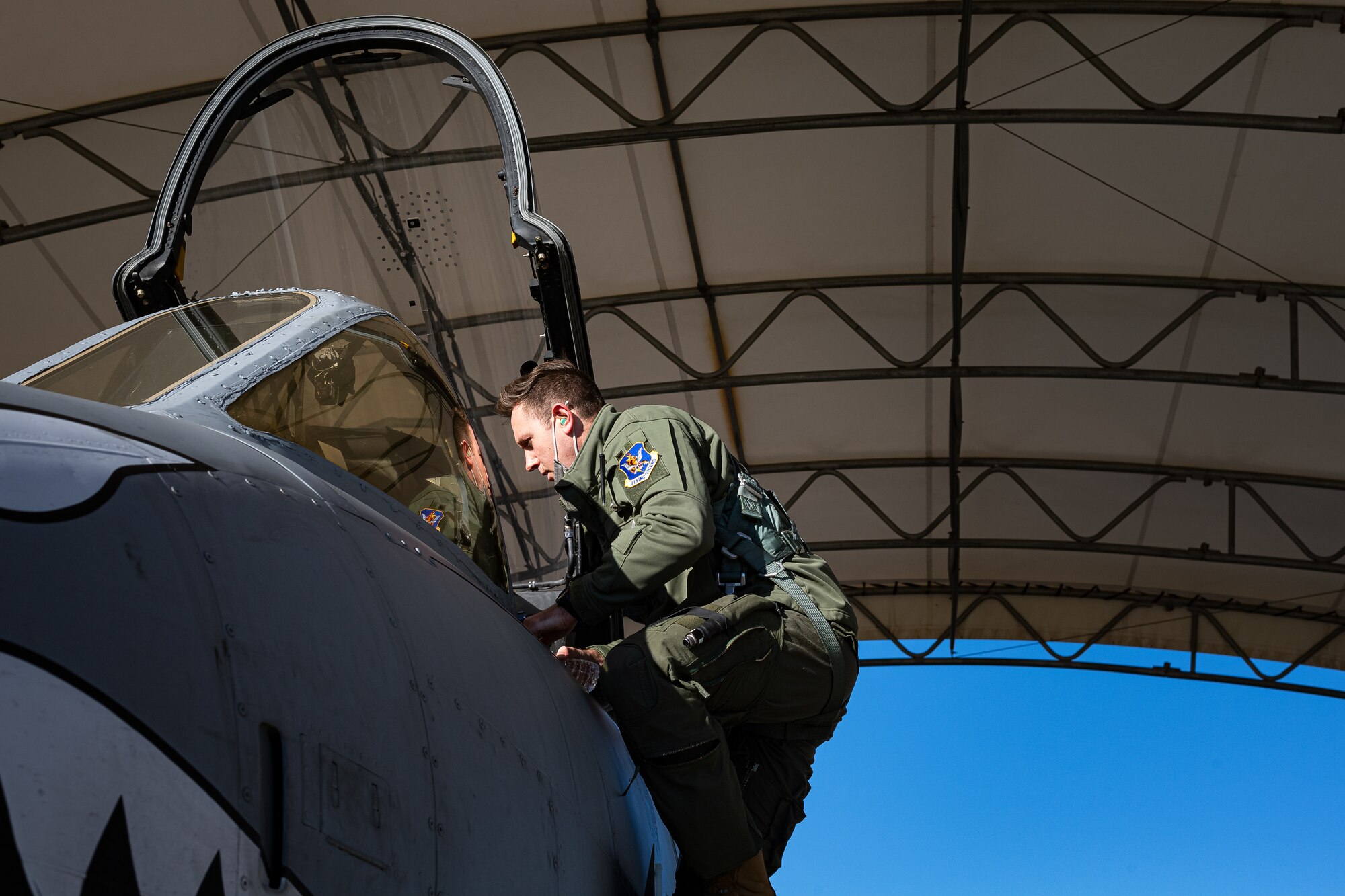 A photo of a pilot climbing into an aircraft