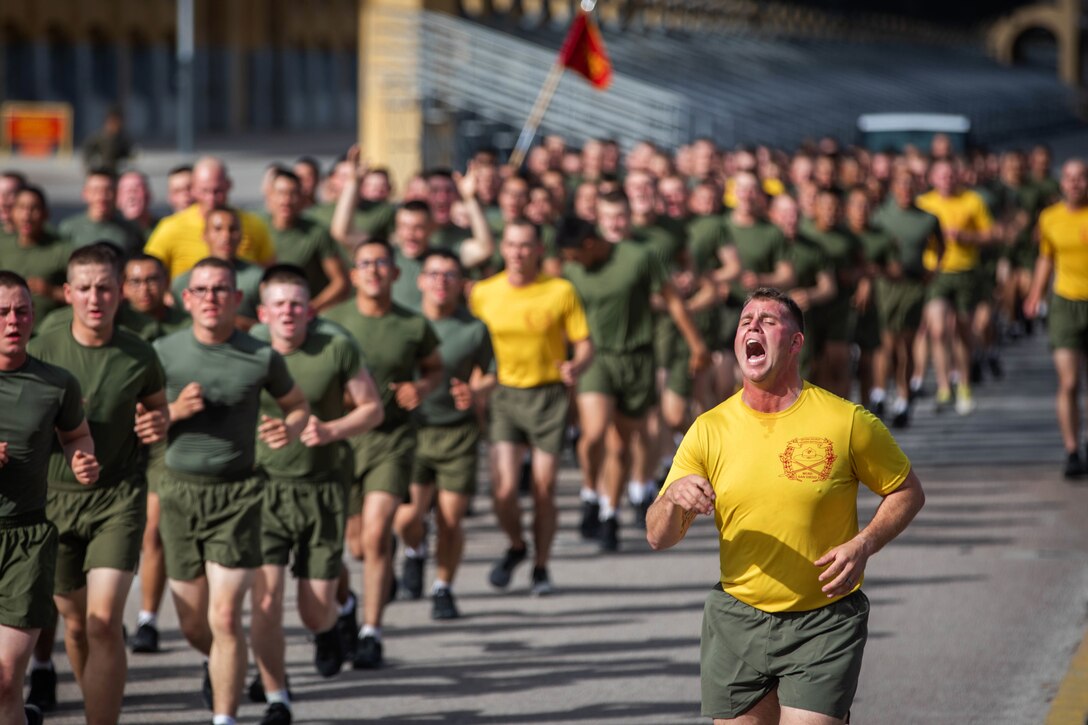 A Marine chants while running alongside a group of other Marine runners.