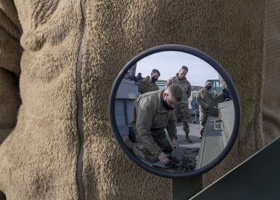 Photo of Airmen working on equipment.