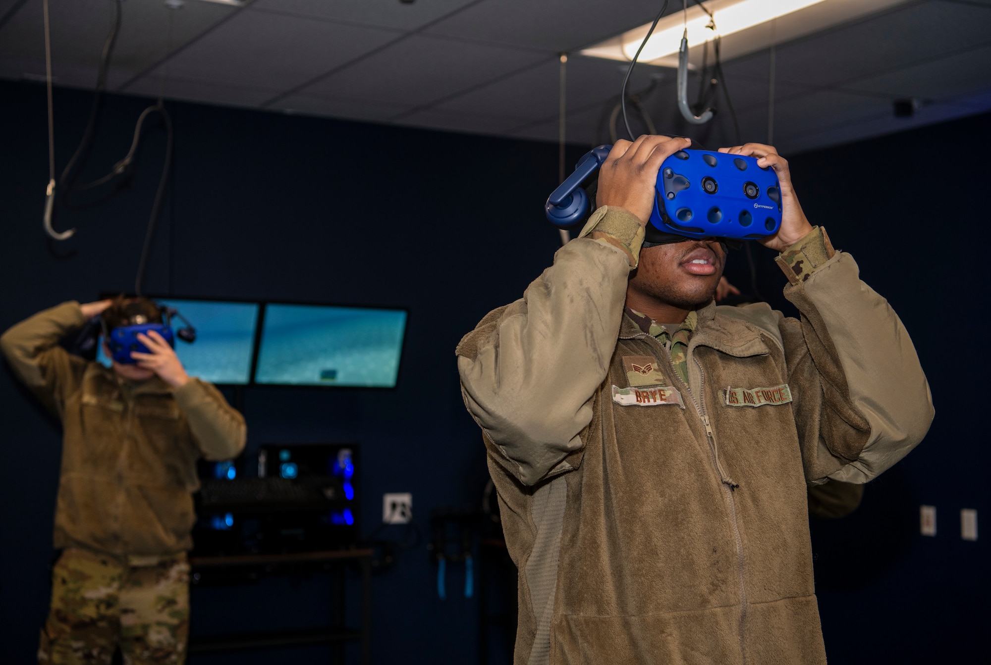 Senior Airman Curtis Brye, 7th Civil Engineering Squadron firefighter driver, right, and Airman 1st Class Andrew Burr, 7th CES firefighter, put on virtual reality headsets in the 317th Maintenance Group’s VR Lab at Dyess Air Force Base, Texas, Jan. 20, 2021.