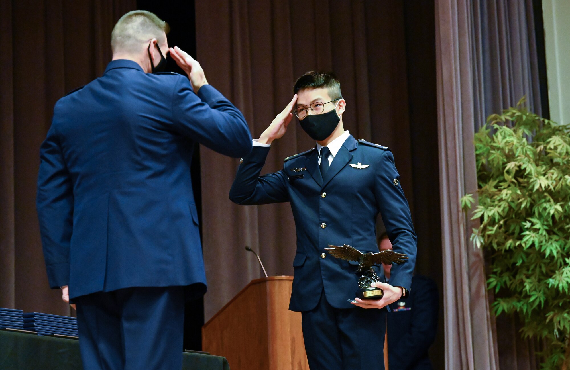 S. Air Force Col. Edward Goebel Jr., 461st Air Control Wing, commander, presents, International Student Lieutenant Tok Jing Ye of the Singapore Air Forces with the Order of Daedalians AETC Commander’s Trophy and challenge coin, during the graduation ceremony, Feb. 5, 2021, on Columbus Air Force Base, Miss. The Order of Daedalians award is presented the student from each graduating class who demonstrates outstanding performance with assigned check rides, daily flying operations, as well as maintains an exceptional commander’s ranking and academic score while completing specialized undergraduate pilot training. (U.S. Air Force photo by Airman 1st Class Jessica Haynie)