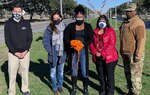 Tonya Lee (center), Joint Base San Antonio-Randolph violence prevention integrator and Randolph Community Action Team members (from left) Dr. Aaron Moffett, Gina Ramirez, Maria Preda and Master Sgt. Ebone Walker pose for a photo after hanging orange ribbons around the installation Feb. 1. Orange is the color for Teen Dating Violence Awareness Month, observed in February.