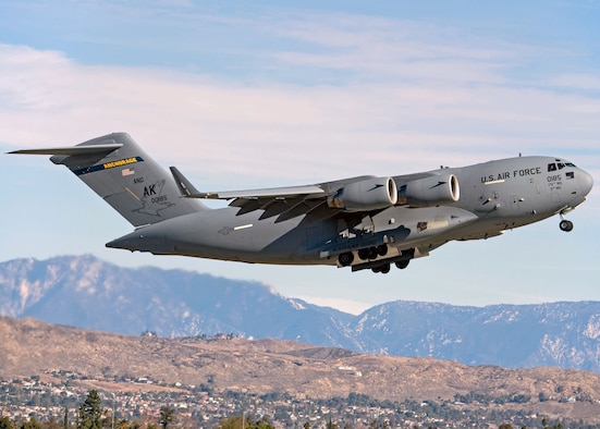 A U.S. Air Force C-17A Globemaster III aircraft assigned to the 176th Wing, Alaska Air National Guard, flies over March Air Reserve Base, California, Jan. 13, 2021. Thirteen Airmen with the 517th AS from Joint Base Elmendorf-Richardson, Alaska, trained for a week in the southwestern U.S. with the C-17, focusing on Agile Combat Employment to train and prepare for global operations in a deployed environment.
