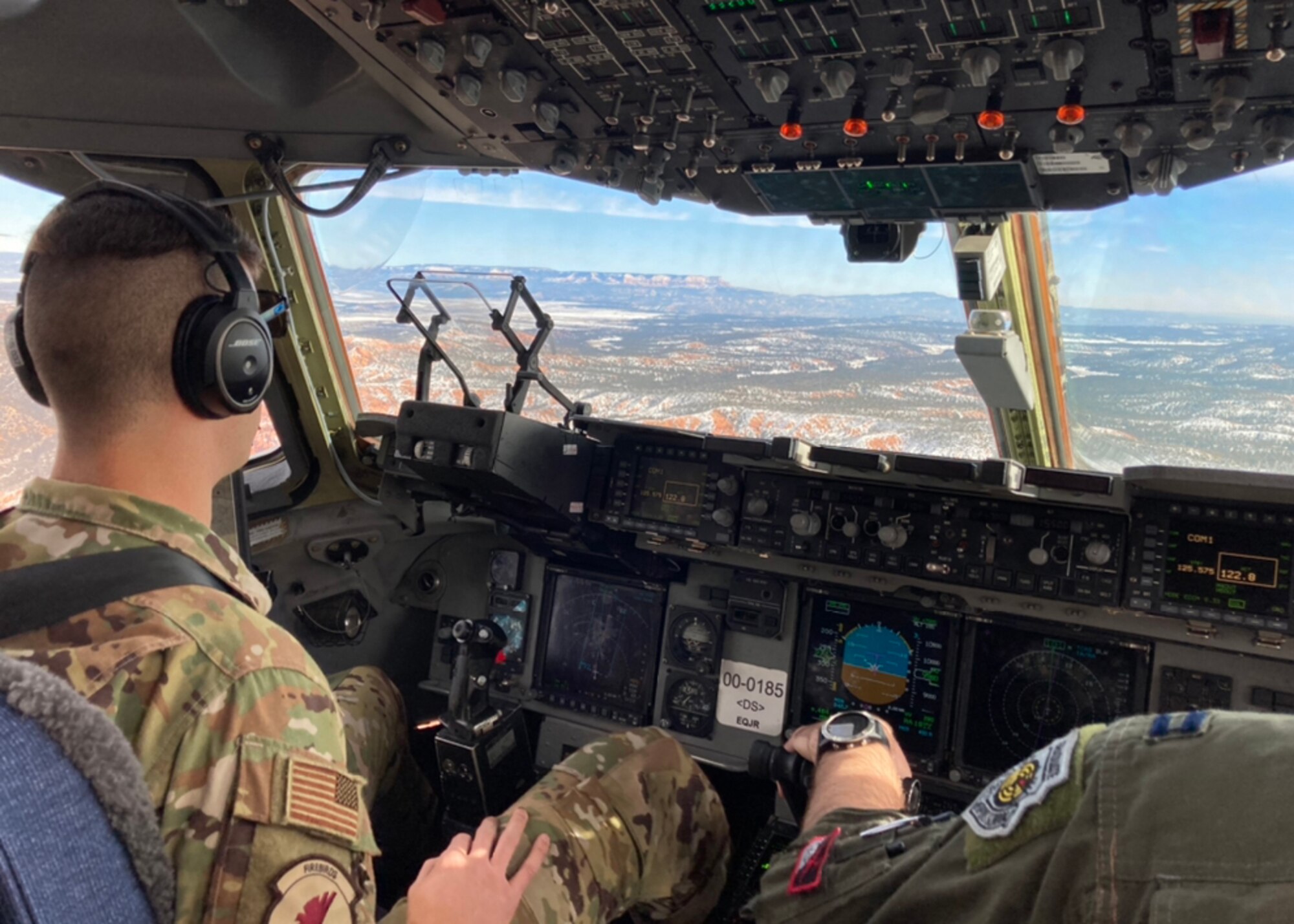 U.S. Air Force Capt. Rob Mello, left, a C-17 pilot with the 517th Airlift Squadron, and U.S. Air Force Capt. Ben Aiken, the 517th AS Weapons and Tactics Flight commander and weapons officer, prepare for a low-altitude maneuver in a U.S. Air Force C-17A Globemaster III aircraft assigned to the 176th Wing, Alaska Air National Guard, over northeastern Arizona, Jan. 9, 2021. Thirteen Airmen with the 517th AS from Joint Base Elmendorf-Richardson, Alaska, trained for a week in the southwestern U.S. with the C-17, focusing on Agile Combat Employment to train and prepare for global operations in a deployed environment.