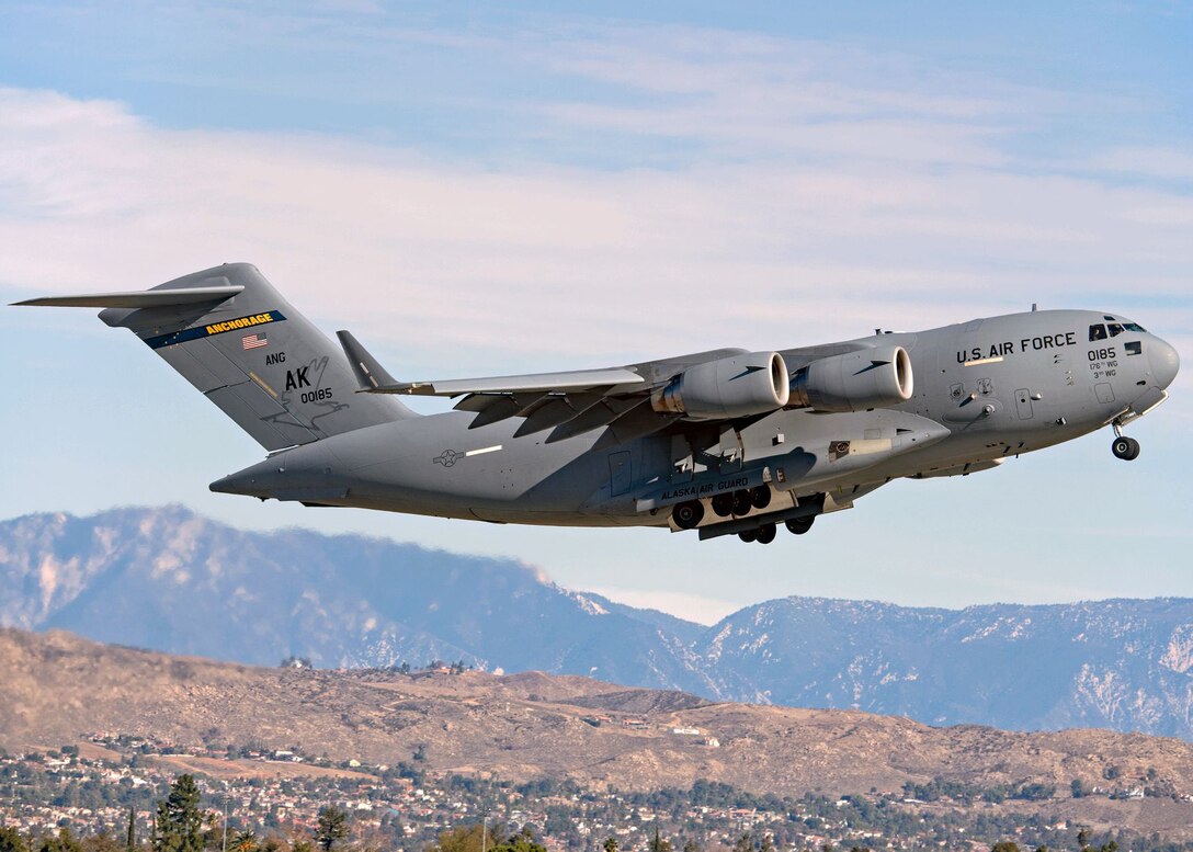 A U.S. Air Force C-17A Globemaster III aircraft assigned to the 176th Wing, Alaska Air National Guard, flies over March Air Reserve Base, California, Jan. 13, 2021. Thirteen Airmen with the 517th AS from Joint Base Elmendorf-Richardson, Alaska, trained for a week in the southwestern U.S. with the C-17, focusing on Agile Combat Employment to train and prepare for global operations in a deployed environment.