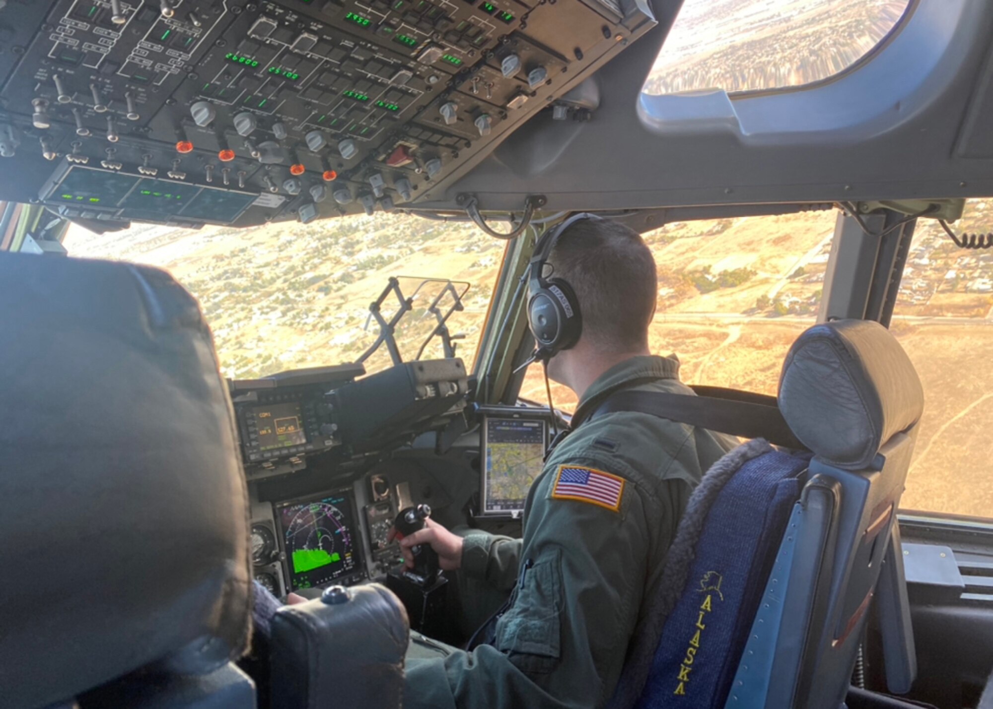 U.S. Air Force 1st Lt. Alex Martin, a C-17 pilot with the 517th Airlift Squadron, performs defensive maneuvers in a U.S. Air Force C-17A Globemaster III aircraft assigned to the 176th Wing, Alaska Air National Guard, over northwestern Colorado, Jan. 9, 2021. Thirteen Airmen with the 517th AS from Joint Base Elmendorf-Richardson, Alaska, trained for a week in the southwestern U.S. with the C-17, focusing on Agile Combat Employment to train and prepare for global operations in a deployed environment.