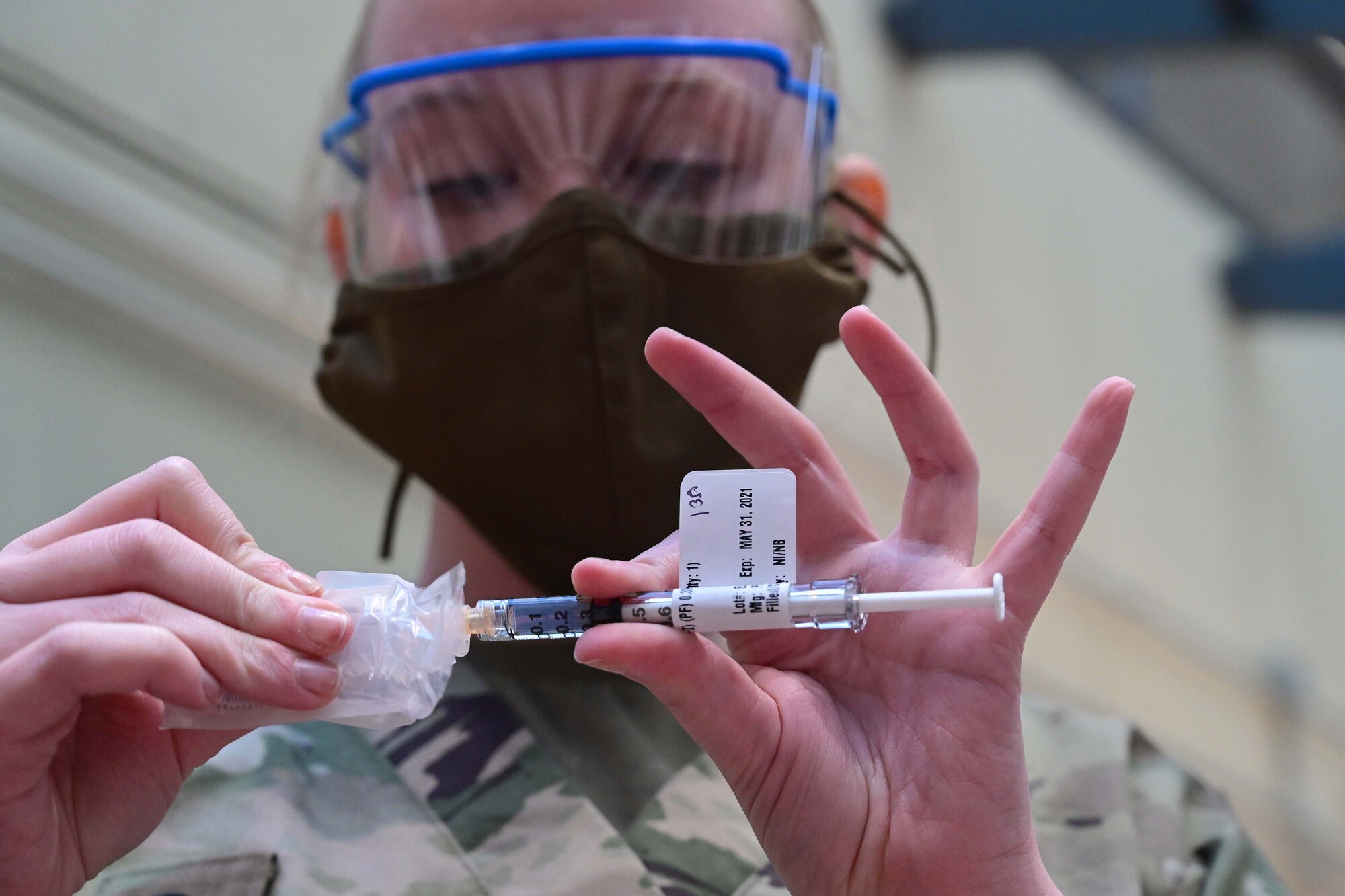 A health worker prepares a syringe with vaccine.