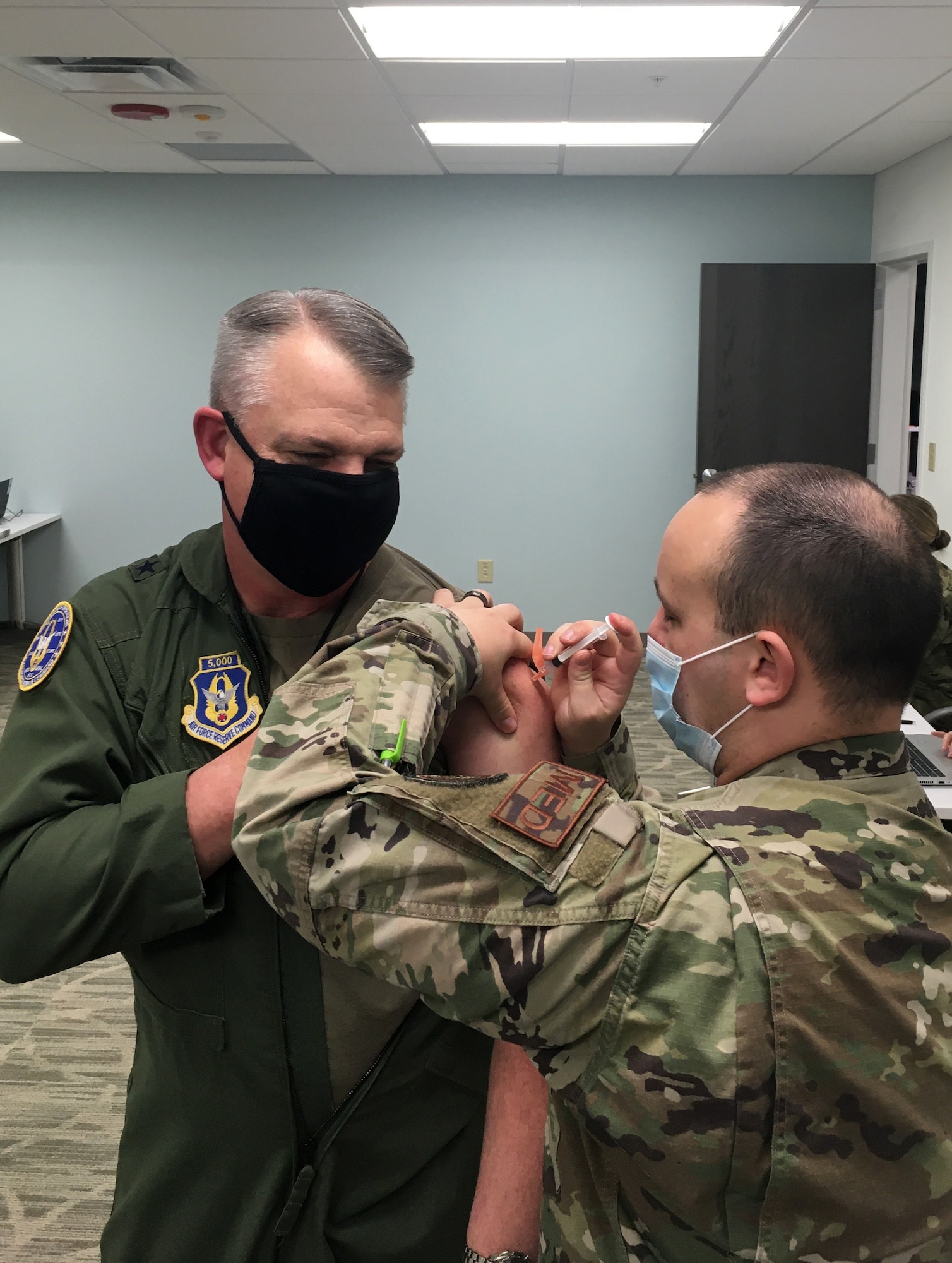 Brig. Gen. Derin Durham, Director of Air, Space and Information Operations for Air Force Reserve Command, is given his second dose of the COVID-19 vaccine by Senior Airman Jarred Wright, a immunization technician with the 78th Medical Group, at Robins Air Force Base, Georgia, Feb. 5, 2021. AFRC leaders have now completed their required two doses of the COVID-19 vaccine. (courtesy photo)