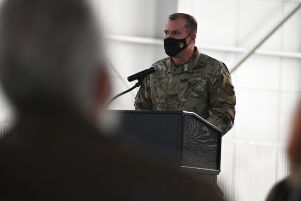 A man in a military uniform talks to people