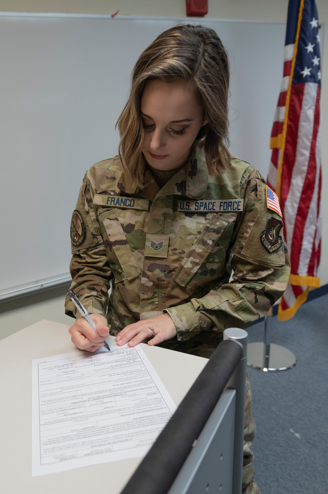 A guardian signs an paper