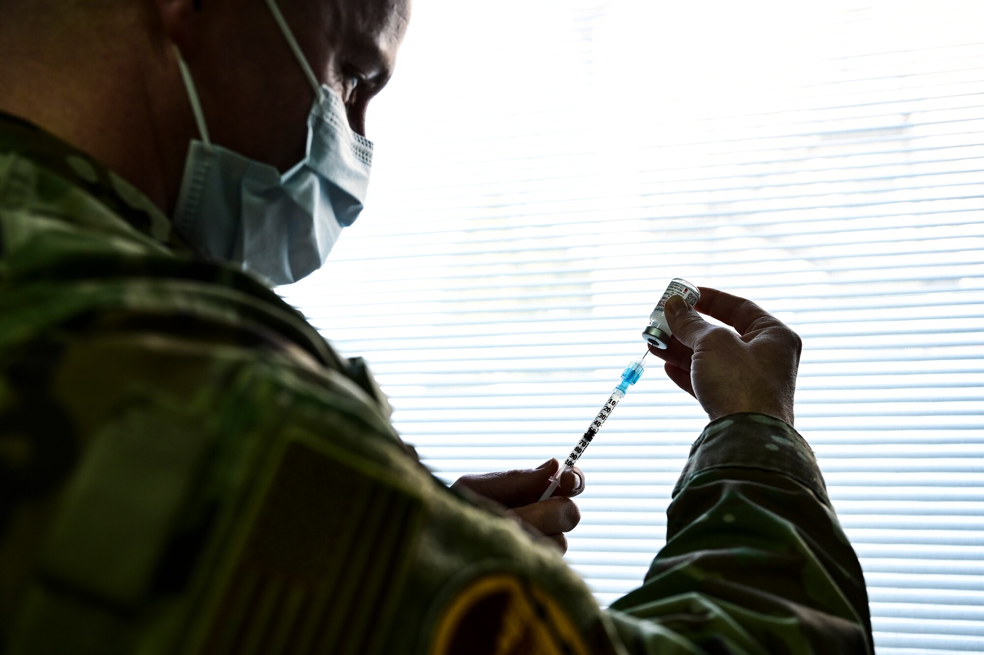 Tech. Sgt. Joseph Anthony, 911th Aeromedical Staging Squadron aeromedical technician, fills a syringe with the COVID-19 vaccine at the Pittsburgh International Airport Air Reserve Station, Pennsylvania, Feb. 4, 2021.