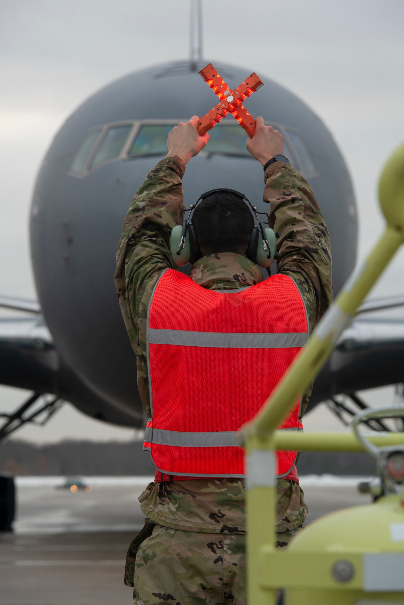 U.S. Air Force Tech. Sgt. Brandon Cevallos, a crew chief assigned to the 157th Air Refueling Wing, New Hampshire Air National Guard, marshalls in the 12th and final KC-46A Pegasus arrival at Pease Air National Guard Base, N.H., Feb. 5, 2021.