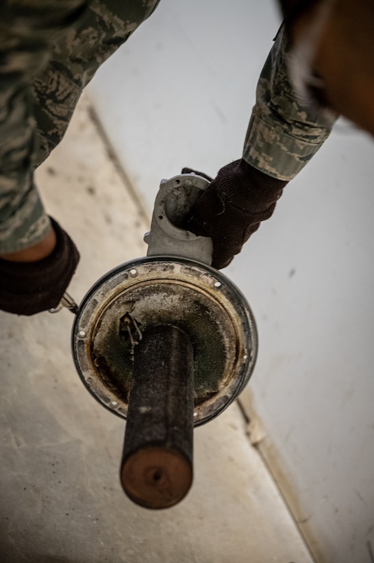 Staff Sgt. Keith Bell, 932nd Civil Engineer Squadron, heating, ventilation, and air conditioning craftsman uses an air compressor to spray off carbon build up from the heating exchanger February 5, 2021, inside building 3651, the 932nd Medical Group building, Scott Air Force Base, Illinois. (U.S. Air Force photo by Christopher Parr)