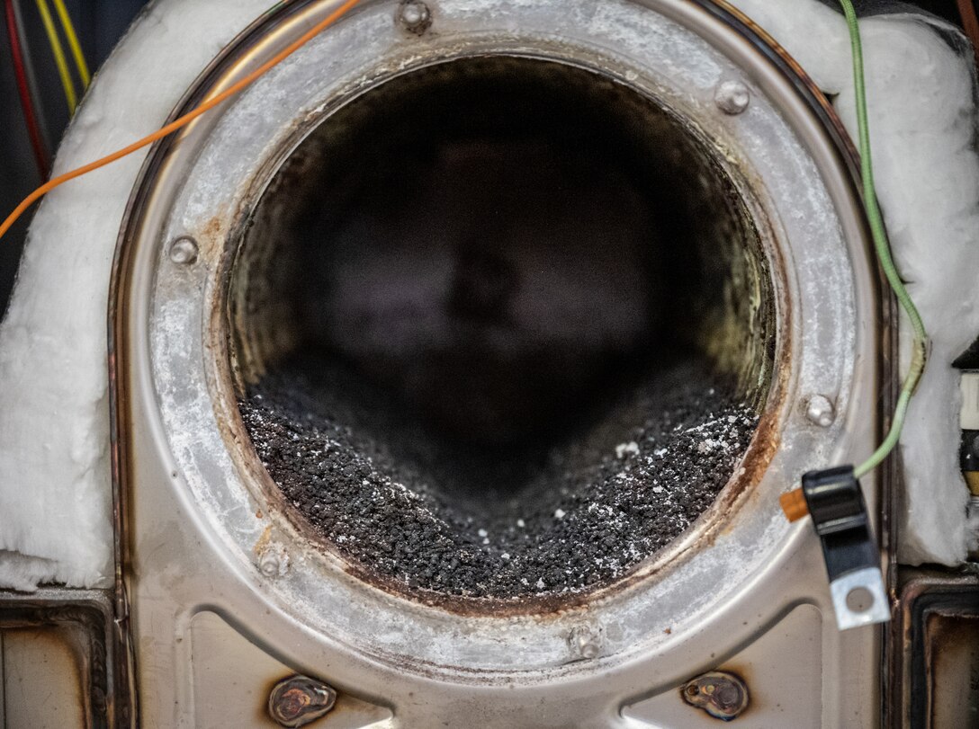 Close up view of the carbon buildup inside a heating boiler February 5, 2021, inside building 3651, the 932nd Medical Group building, Scott Air Force Base, Illinois.  This debris could cause the boiler to malfunction and why it is important to perform regular maintenance.  (U.S. Air Force photo by Christopher Parr)