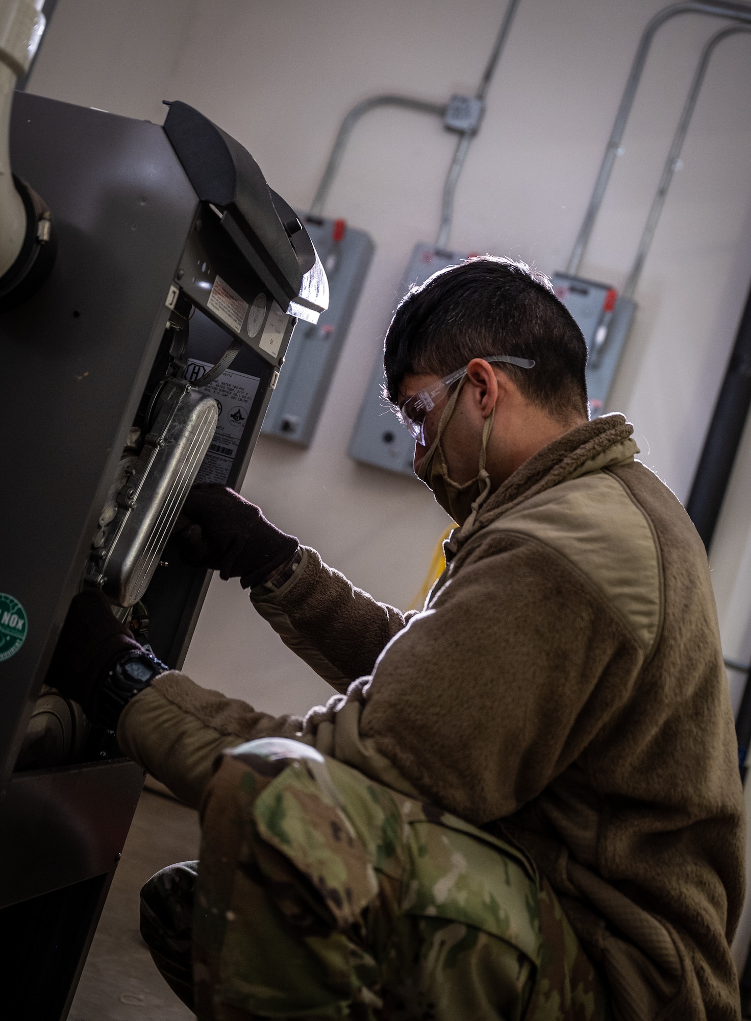 Staff Sgt. Randy Cintron 932nd Civil Engineer Squadron, heating, ventilation, and air conditioning journeyman reinstalls the heating exchanger from a heating boiler after it was cleaned of all carbon buildup February 5, 2021, inside building 3651, the 932nd Medical Group building, Scott Air Force Base, Illinois. (U.S. Air Force photo by Christopher Parr)