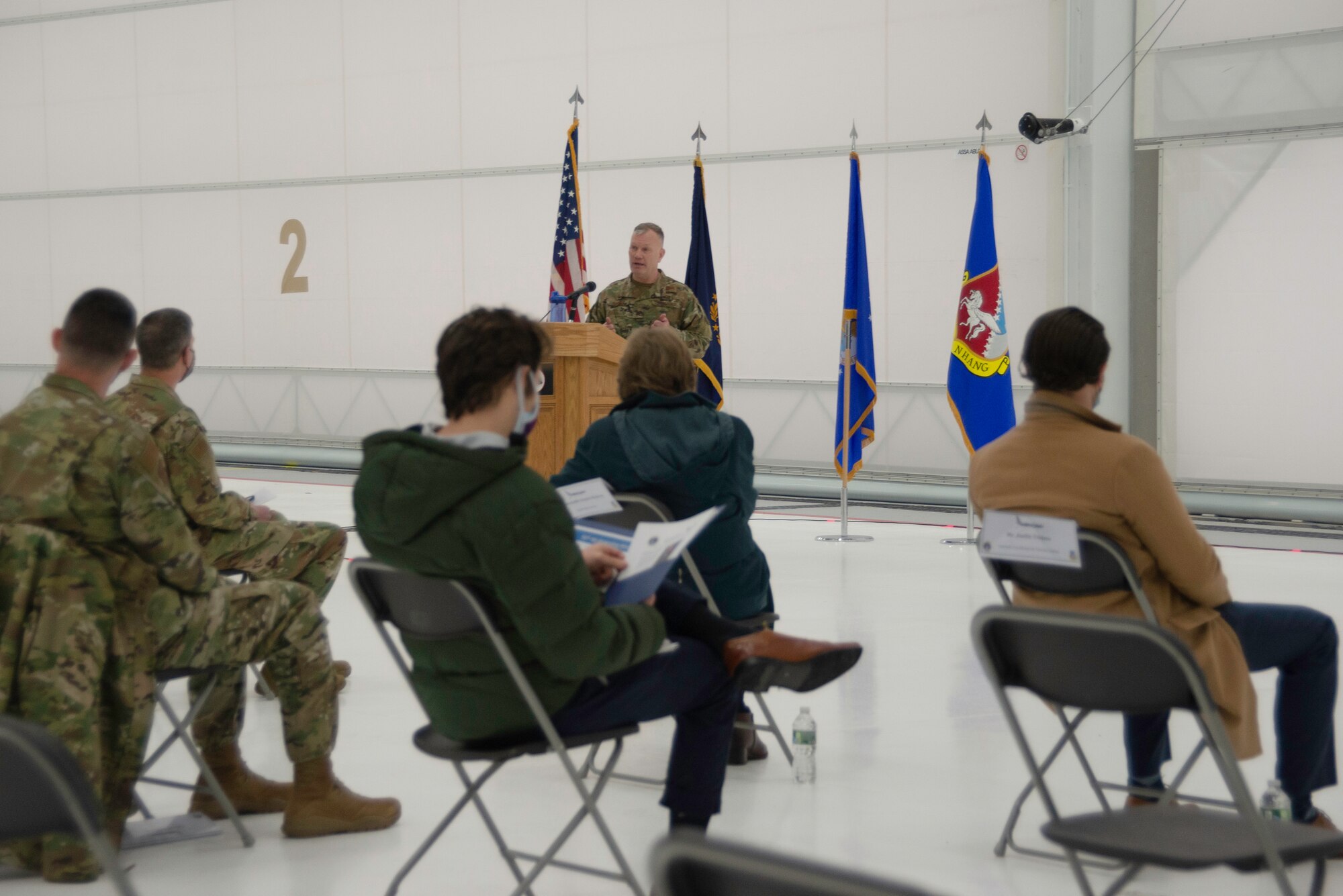 U.S. Air Force Col. John Pogorek, 157th Air Refueling Wing commander, addresses dignitaries gathered inside a hangar for the delivery of the unit's twelfth and final aircraft to Pease Air National Guard Base, Newington, N.H., Feb. 5, 2021.