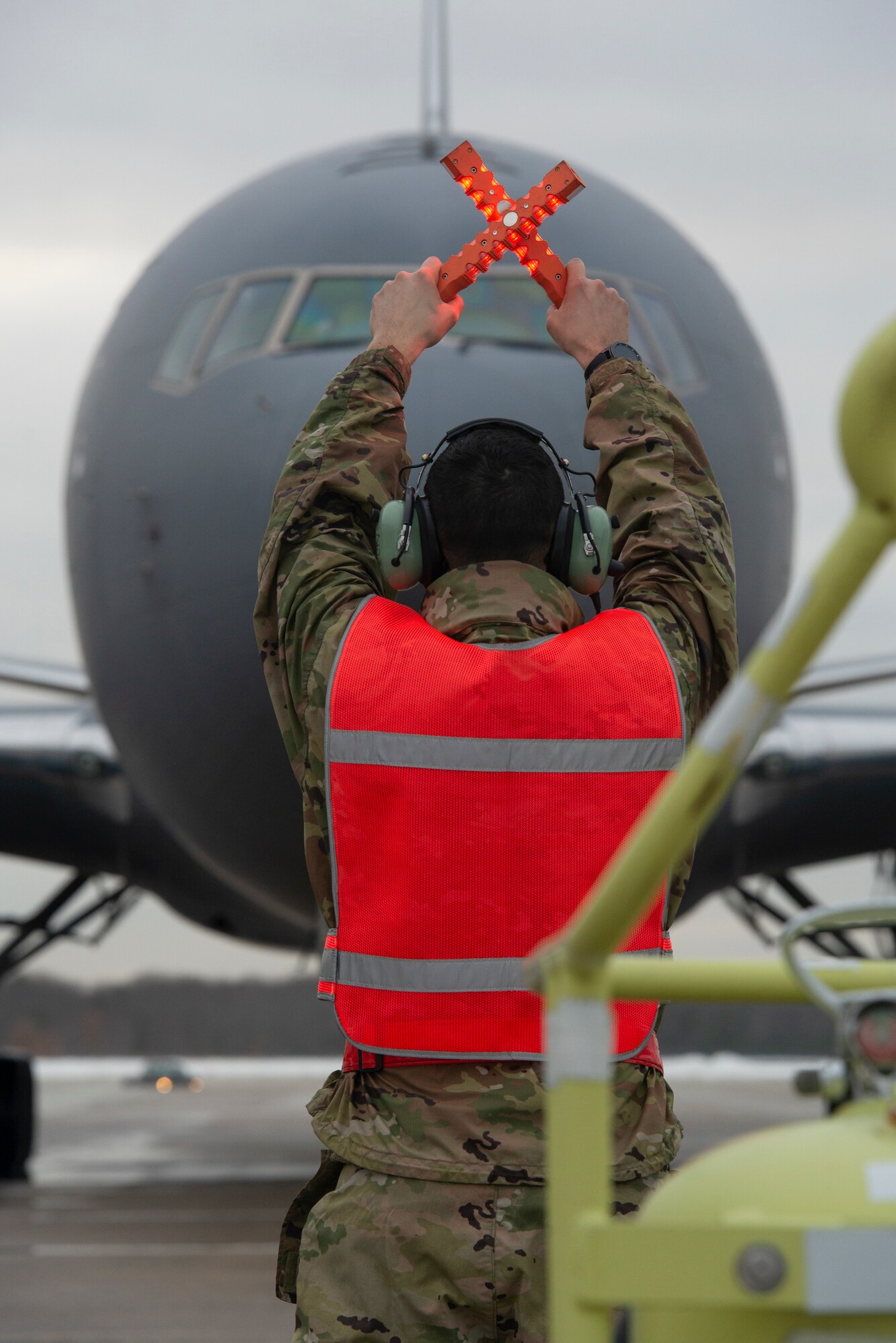 U.S. Air Force Tech. Sgt. Brandon Cevallos, a crew chief assigned to the 157th Air Refueling Wing, New Hampshire Air National Guard, marshalls in the 12th and final KC-46A Pegasus arrival at Pease Air National Guard Base, N.H., Feb. 5, 2021.