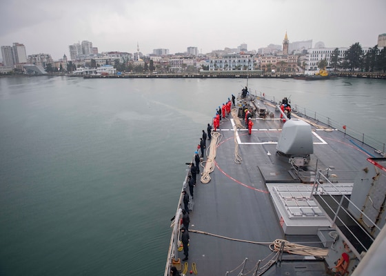 Sailors aboard the Arleigh Burke-class guided-missile destroyer USS Donald Cook (DDG 75) man the rails as the ship arrives in Batumi, Georgia, Feb. 5, 2021.