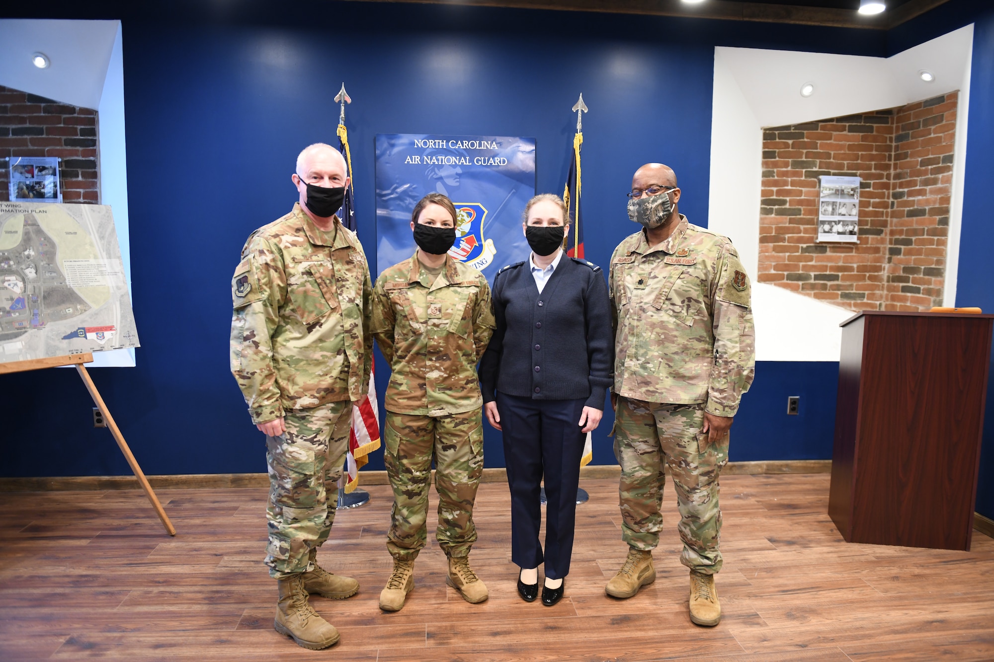 From left to right, U.S. Air Force Brigadier General Allan R. Cecil, Tech. Sgt. Brittney Morgan, Maj. Christy Roddy, and Lt. Col. Craig Robinson pose for a photo following a coin presentation to Tech.  Sgt. Morgan, while at the, NCANG Base, Charlotte Douglas International Airport, February 7. 2021. Brigadier General Cecil presented TSgt Morgan with a coin in recognition of her outstanding performance as a recruiter, going above her yearly recruiting goal by 147% during 2020.