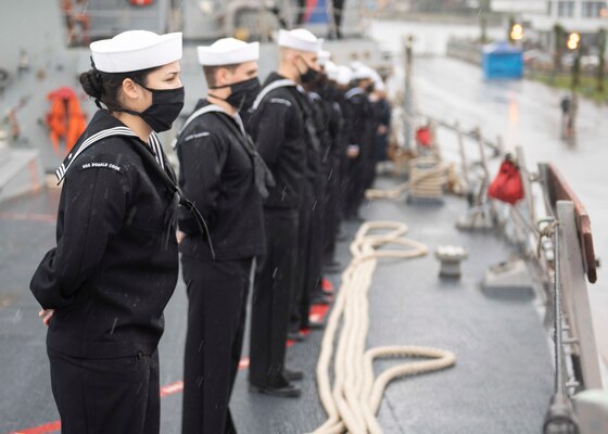 Sailors aboard the Arleigh Burke-class guided-missile destroyer USS Donald Cook (DDG 75) man the rails as the ship arrives in Batumi, Georgia, Feb. 5, 2021.