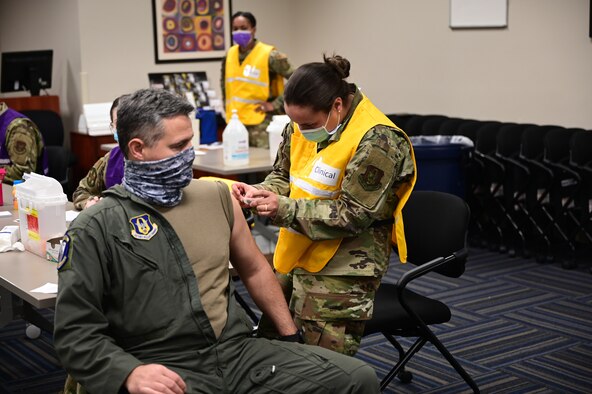 Air Force Reserve Lt. Col. Jeremy Wagner, commander of the 327th Airlift Squadron, voluntarily receives the Moderna COVID19 vaccine from fellow reserve medical professionals at Little Rock Air Force Base, Ark., Feb. 7, 2021.The two-dose vaccines were recently approved by the Food and Drug Administration under an emergency use authorization and are currently offered to DoD personnel on a voluntary basis.  (U.S. Air Force  photo by Airman 1st Class Julia Ford)