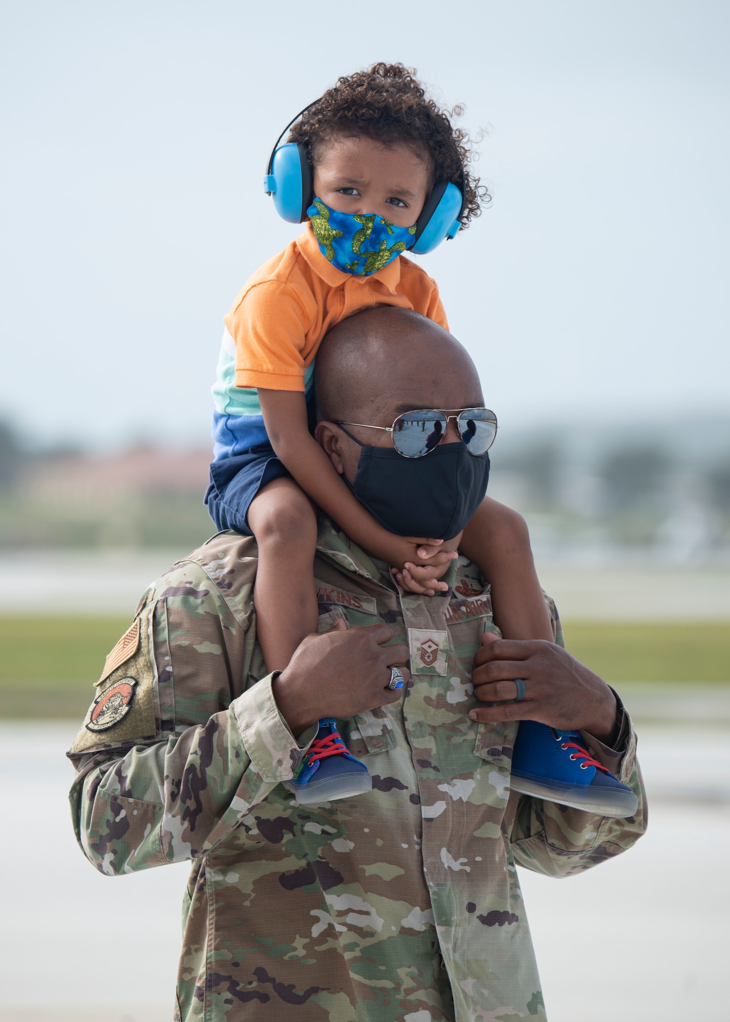 Master Sgt. Marcus Hawkins, 36th Munitions Squadron first sergeant, holds his son on his shoulders during a group flight line engagement for Exercise Cope North 2021 at Andersen Air Force Base, Guam, Feb. 5, 2021. Exercise Cope North 2021 is an annual U.S. Pacific Air Forces joint/combined, trilateral field training exercise occurring Feb. 3-19, 2021. (U.S. Air Force photo by Senior Airman Aubree Owens)