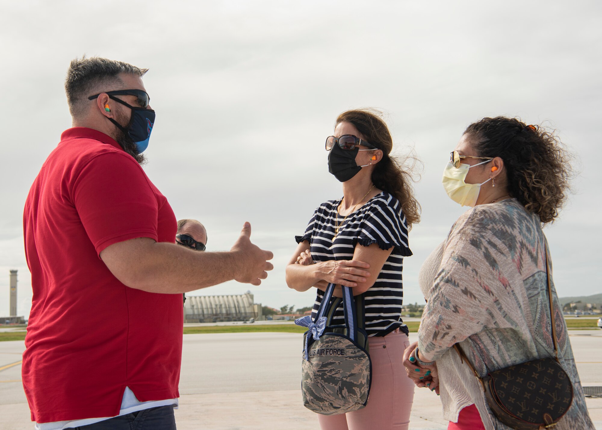 James Sherrill, spouse of 36th Maintenance Squadron commander, speaks with Lisa Sloane, spouse of 36th Wing commander, and Cynthia Copple, 36th Wing command chief, during a group flight line engagement for Exercise Cope North 2021 at Andersen Air Force Base, Guam, Feb. 5, 2021. Exercise Cope North 2021 is an annual U.S. Pacific Air Forces joint/combined, trilateral field training exercise occurring Feb. 3-19, 2021. (U.S. Air Force photo by Senior Airman Aubree Owens)