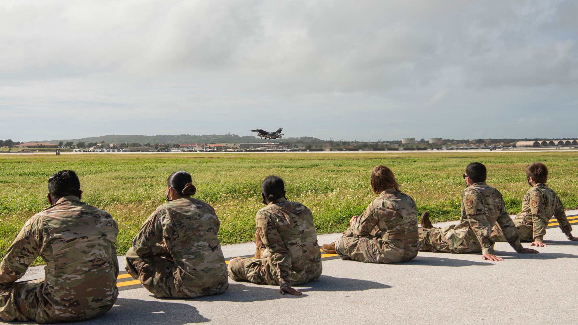 Airmen assigned to the 36th Maintenance Group watch as a U.S. Air Force F-16 Fighting Falcon, assigned to the 18th Aggressor Squadron, Eielson Air Force Base, Alaska, takes off during a group flight line engagement for Exercise Cope North 2021 at Andersen AFB, Guam, Feb. 5, 2021. Exercise Cope North 2021 is an annual U.S. Pacific Air Forces joint/combined, trilateral field training exercise occurring Feb. 3-19, 2021. The exercise includes participants from the U.S. Air Force, U.S. Navy, U.S. Marine Corps, Japan Air Self-Defense Force and Royal Australian Air Force. (U.S. Air Force photo by Senior Airman Aubree Owens)