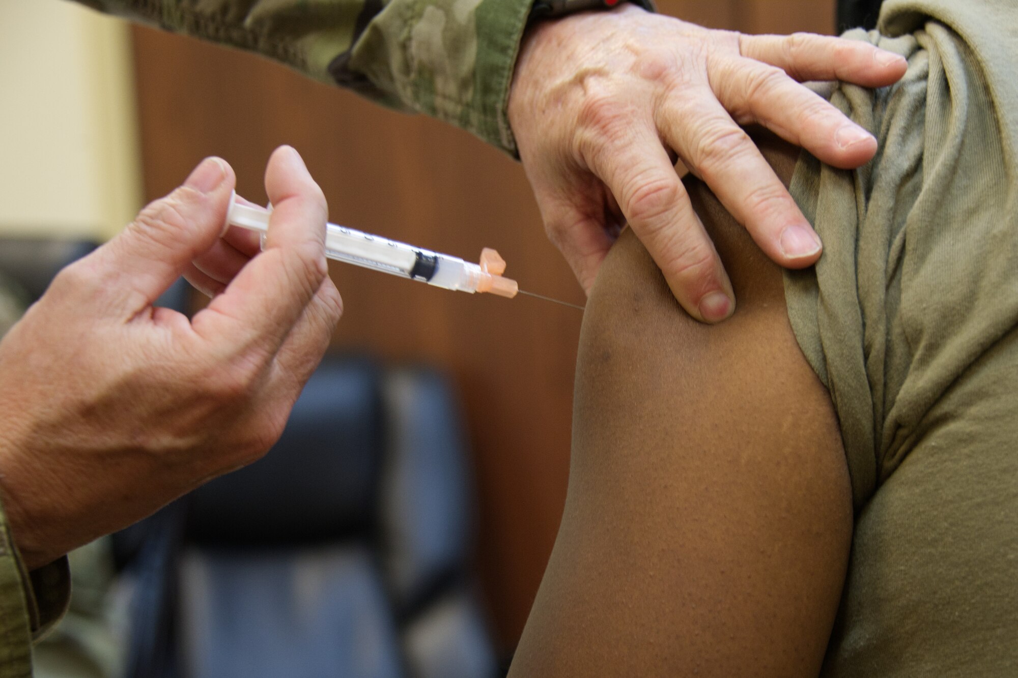 Photo of needle going into an arm.