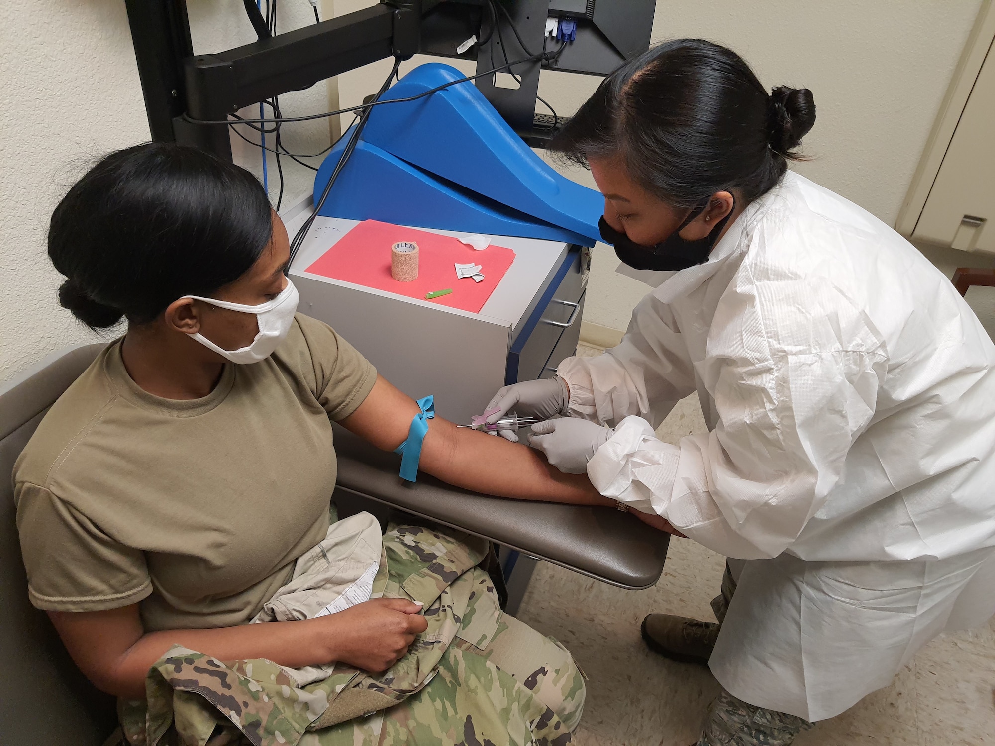 Airman 1st Class Shayla Tillman, 403rd Force Support Squadron personnelist, has blood drawn for routine lab work by Tech. Sgt. Jasmine Wong, 403rd Aeromedical Staging Squadron lab technician, Feb. 6, 2021. The 403rd ASTS is responsible for ensuring that the Reserve Citizen Airmen of the 403rd Wing are current or 'green' on their Individual Medical Readiness status; which includes providing immunizations, optometry services, dental x-rays and exams, lab draws, audiograms, and physicals. (U.S. Air Force photo by Master Sgt. Jessica Kendziorek/ photo permission granted by Airman 1st Class Shayla Tillman)