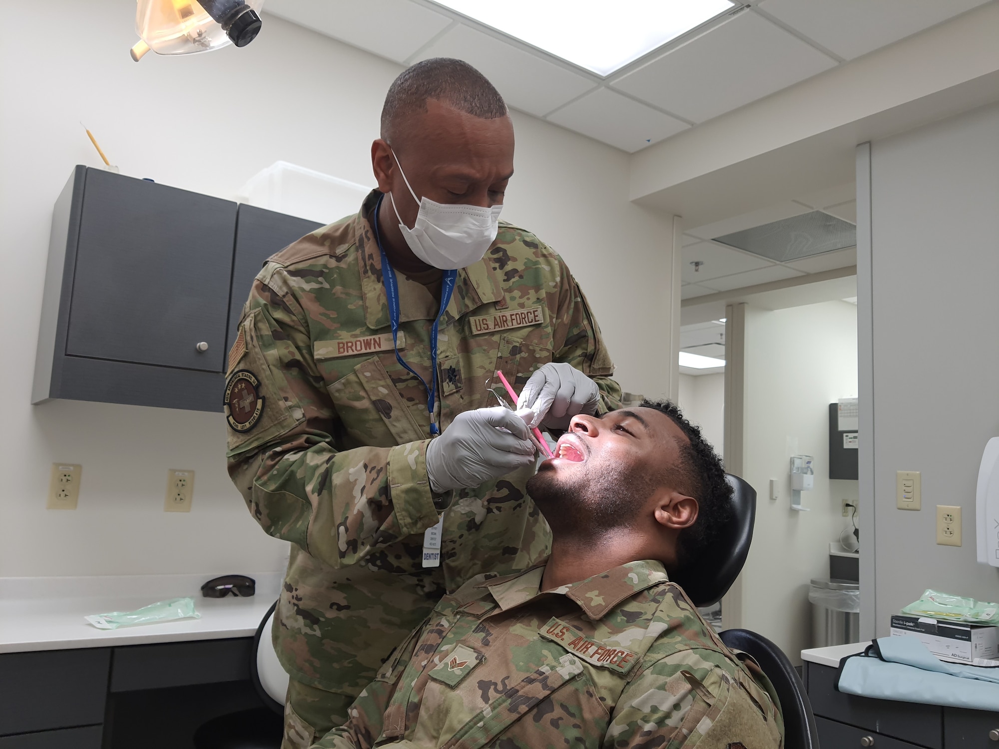 Senior Airman D'Orsay Scott, 41st Aerial Port Squadron air transportation specialist, receives his dental exam from Lt. Col. Jeffrey Brown, 403rd Aeromedical Staging Squadron dentist, Feb. 6, 2021. The 403rd ASTS is responsible for ensuring that the Reserve Citizen Airmen of the 403rd Wing are current or 'green' on their Individual Medical Readiness status; which includes providing immunizations, optometry services, dental x-rays and exams, lab draws, audiograms, and physicals. (U.S. Air Force photo by Master Sgt. Jessica Kendziorek/ photo permission granted by Senior Airman D'Orsay Scott)