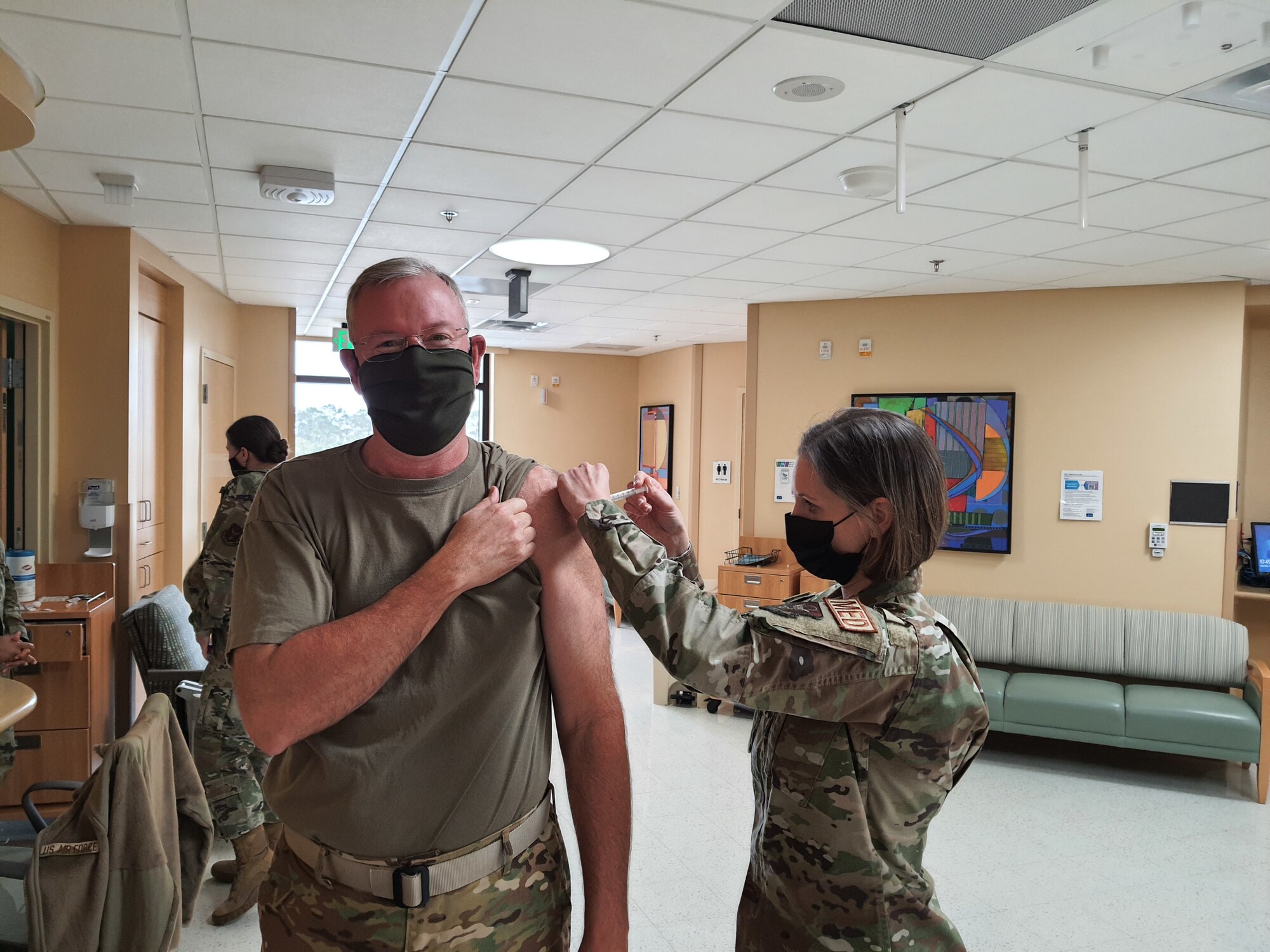 Col. Jeffrey Van Dootingh, 403rd Wing commander, receives his first dose of the COVID vaccine, Feb. 6, 2021 from Lt. Col. Sabrina Hawkins, 403rd Aeromedical Staging Squadron nurse. The 403rd Wing received the vaccine for the February Unit Training Assembly and the 403rd ASTS began administering the vaccine to wing members that volunteered to take it, based on a tier system that prioritizes personnel at risk of being exposed daily to receive it first. (U.S. Air Force photo by Master Sgt. Jessica Kendziorek/ Photo permission granted by Col. Jeffrey Van Dootingh)