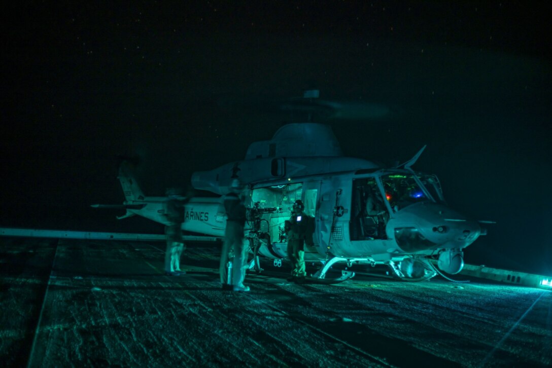 210107-M-UV498-1127 INDIAN OCEAN (Jan. 7, 2021) – U.S. Marines with Marine Medium Tiltrotor Squadron 164 (Reinforced), 15th Marine Expeditionary Unit conduct pre-flight checks on a UH-1Y Venom in preparation for takeoff from the flight deck of the amphibious transport dock ship USS Somerset (LPD 25). The Makin Island Amphibious Ready Group and the 15th MEU are conducting operations in the U.S. 6th Fleet area of responsibility. (U.S. Marine Corps photo by Lance Cpl. Mackenzie Binion)