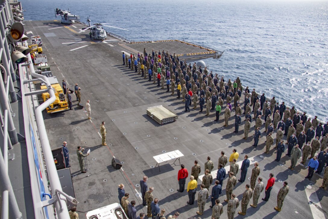 210117-M-PQ459-1060 INDIAN OCEAN (Jan. 17, 2021) – U.S. Marines with the 15th Marine Expeditionary Unit and Sailors assigned the amphibious assault ship USS Makin Island (LHD 8) stand in formation during an award ceremony on the ship’s flight deck. The Makin Island Amphibious Ready Group and the 15th MEU are conducting operations in the U.S. 6th Fleet area of responsibility. (U.S. Marine Corps photo by Sgt. Sarah Stegall)
