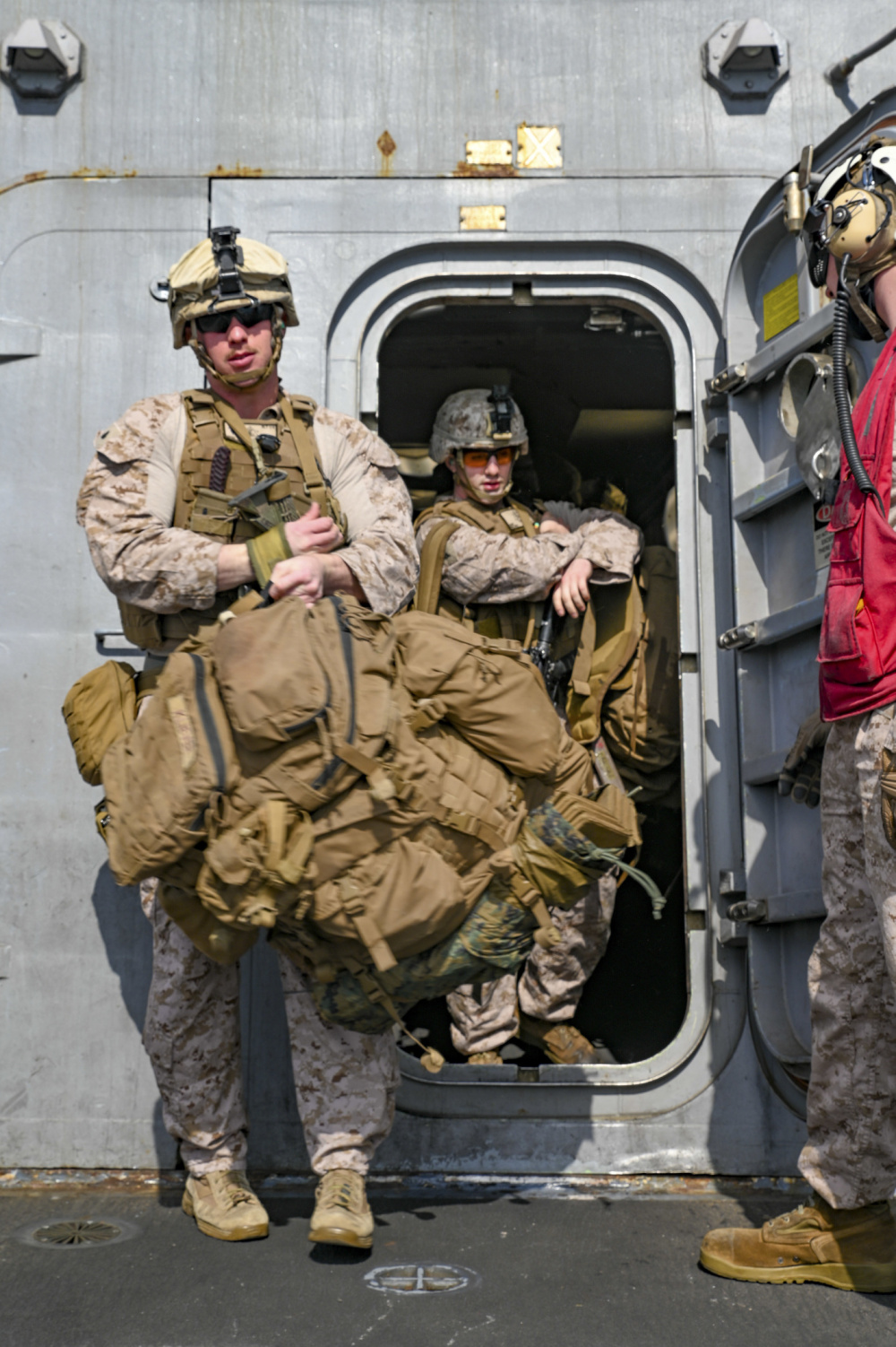 210125-M-ZN327-1018 ARABIAN GULF (Jan. 25, 2021) – U.S. Marines with Alpha Company, Battalion Landing Team 1/4, 15th Marine Expeditionary Unit, step onto the flight deck of the amphibious transport dock ship USS San Diego (LPD 22). San Diego, part of the Makin Island Amphibious Ready Group, and the 15th MEU are deployed to the U.S. 5th Fleet area of operations in support of naval operations to ensure maritime stability and security in the Central Region, connecting the Mediterranean and the Pacific through the western Indian Ocean and three strategic choke points. (U.S. Marine Corps photo by Cpl. Britany Rowlett)