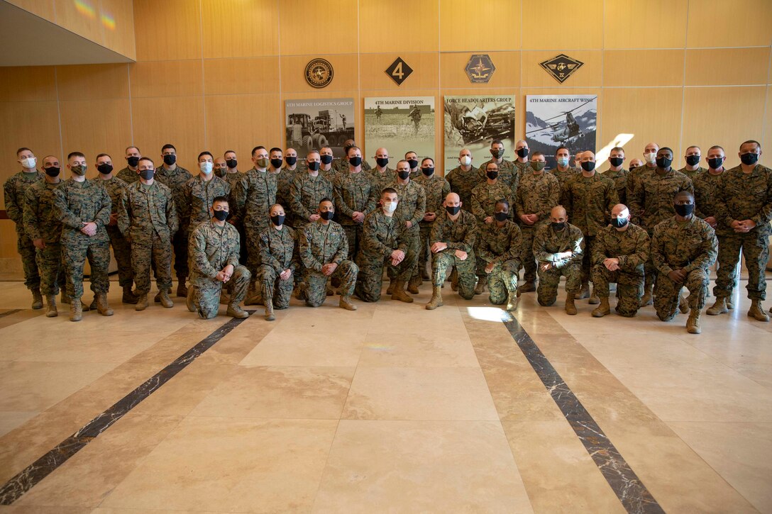 The 19th Sergeant Major of the Marine Corps, Sgt. Maj. Troy E. Black, poses for a group photo with Marines attending the First Sergeant Symposium at Marine Corps Forces Reserve, New Orleans, La, Feb. 4, 2021. The Sergeant Major of the Marine Corps conducted the visit to speak with Staff-Non Commissioned Officer leadership about his priorities for the next 12 months and answer any questions. Marine Forces Reserve organizes, mans, equips, trains, and sustains more than 40,000 Drilling Reserve Marines and some 60,000 Individual Ready Reserve Marines to support Theater Security Cooperation Exercises and Overseas Contingency Operation requirements. (U.S. Marine Corps photo by Sgt. Victoria Ross)