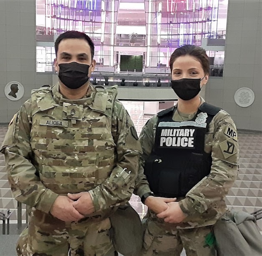 Staff Sgt. Roberto Alicea, of the 1166th Transportation Company, and his daughter, Pvt. Felicia Alicea of the 747th Military Police Company poses for a photo at the Ronald Reagan Center on Tuesday, Feb. 2, 2021, while deployed to Washington, D.C., as part of Task Force Freedom