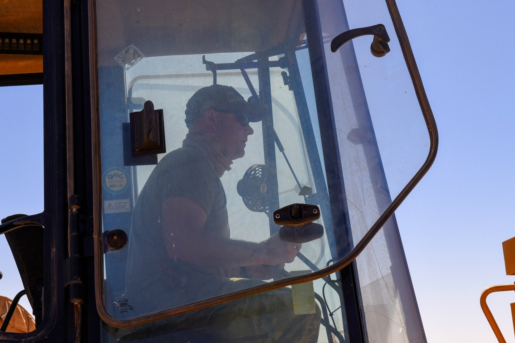 U.S. Air Force Master Sgt. Sean Kerrigan, 724th Expeditionary Air Base Squadron Civil Engineer Flight water and fuels maintenance shop supervisor, operates a backhoe to excavate dirt around a ruptured water main at Nigerien Air Base 201, Agadez, Niger, Feb. 2, 2021. The civil engineer flight worked to successfully locate a water main break on the logistics readiness flight compound. (U.S. Air Force photo by Senior Airman Gabrielle Winn)