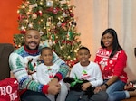 family in front of christmas tree