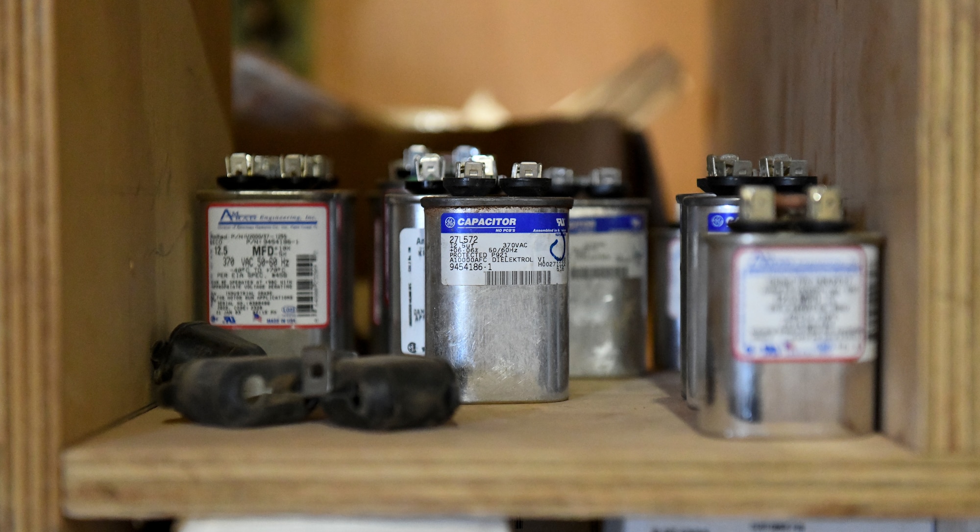 Capacitor’s sit on a shelf prior to being used in a field deployable environmental control unit at Nigerien Air Base 201, Agadez, Niger, Feb. 2, 2021. An FDECU is a cooling unit that is used in all facilities at Air Base 201 and are maintained by Airmen in the Civil Engineer Flight heating, ventilation, air conditioning and refrigeration shop. (U.S. Air Force photo by Senior Airman Gabrielle Winn)