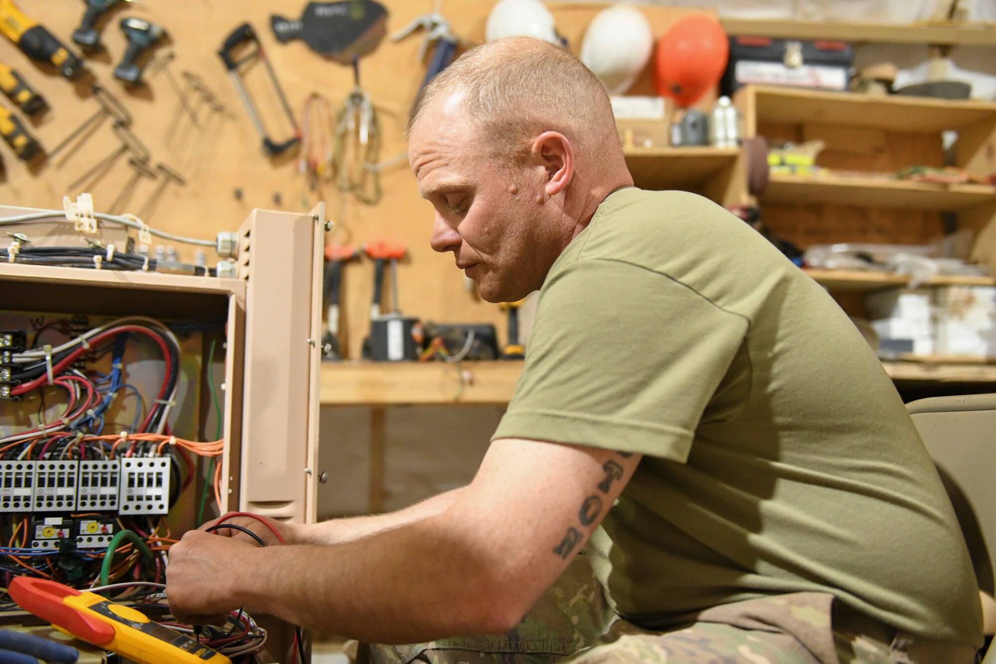 U.S. Air Force Tech. Sgt. Eric Smith, 724th Expeditionary Air Base Squadron Civil Engineer Flight heating, ventilation, air conditioning and refrigeration craftsman, troubleshoots a device on a field deployable environmental control unit at Nigerien Air Base 201, Agadez, Niger, Feb. 2, 2021. HVAC/R Airmen are responsible for the mechanical systems that keep Air Base 201’s temperature controlled. (U.S. Air Force photo by Senior Airman Gabrielle Winn)