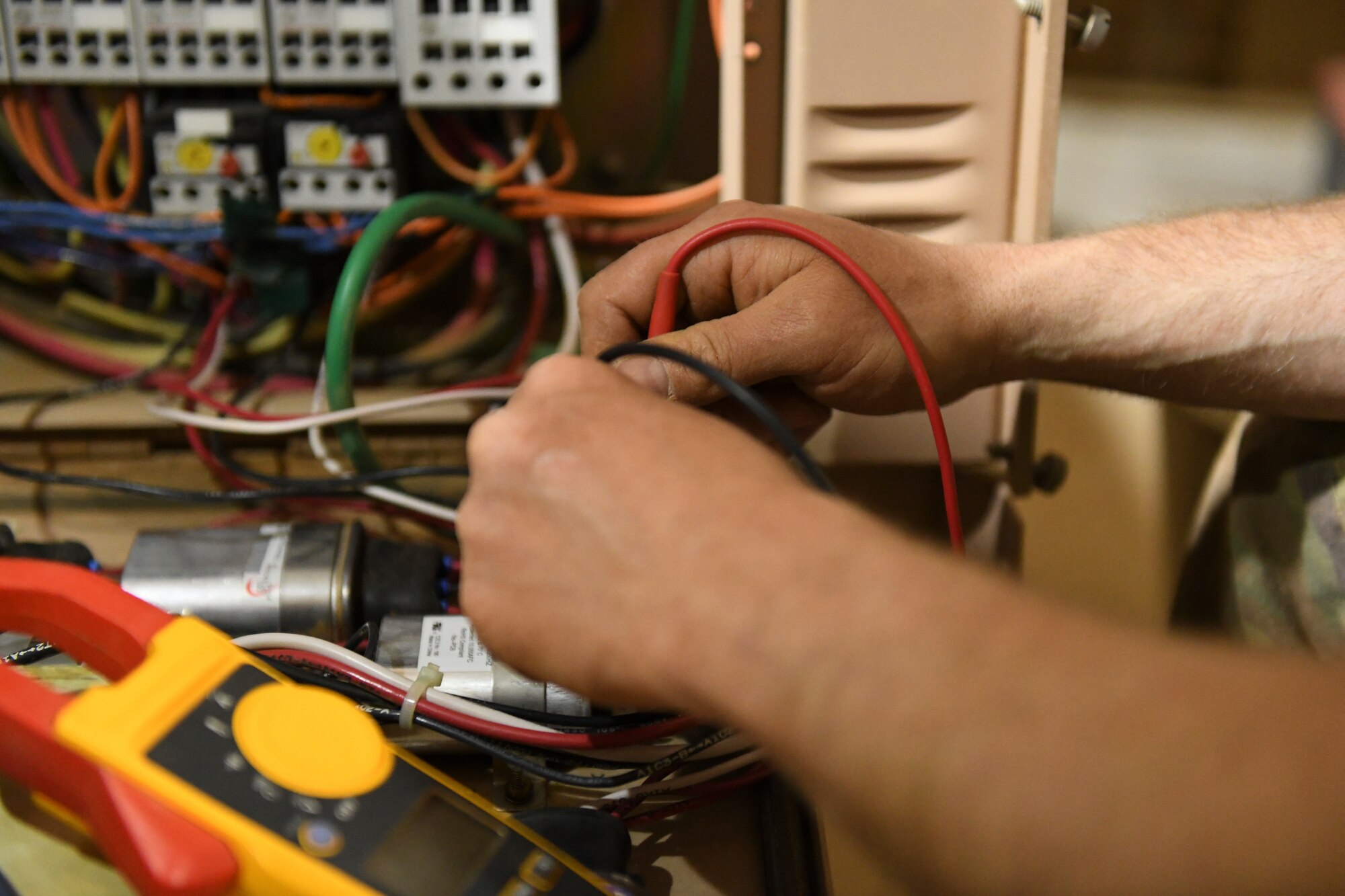 U.S. Air Force Tech. Sgt. Eric Smith, 724th Expeditionary Air Base Squadron Civil Engineer Flight heating, ventilation, air conditioning and refrigeration craftsman, troubleshoots a device on a field deployable environmental control unit at Nigerien Air Base 201, Agadez, Niger, Feb. 2, 2021. HVAC/R Airmen are responsible for the mechanical systems that keep Air Base 201’s temperature controlled. (U.S. Air Force photo by Senior Airman Gabrielle Winn)