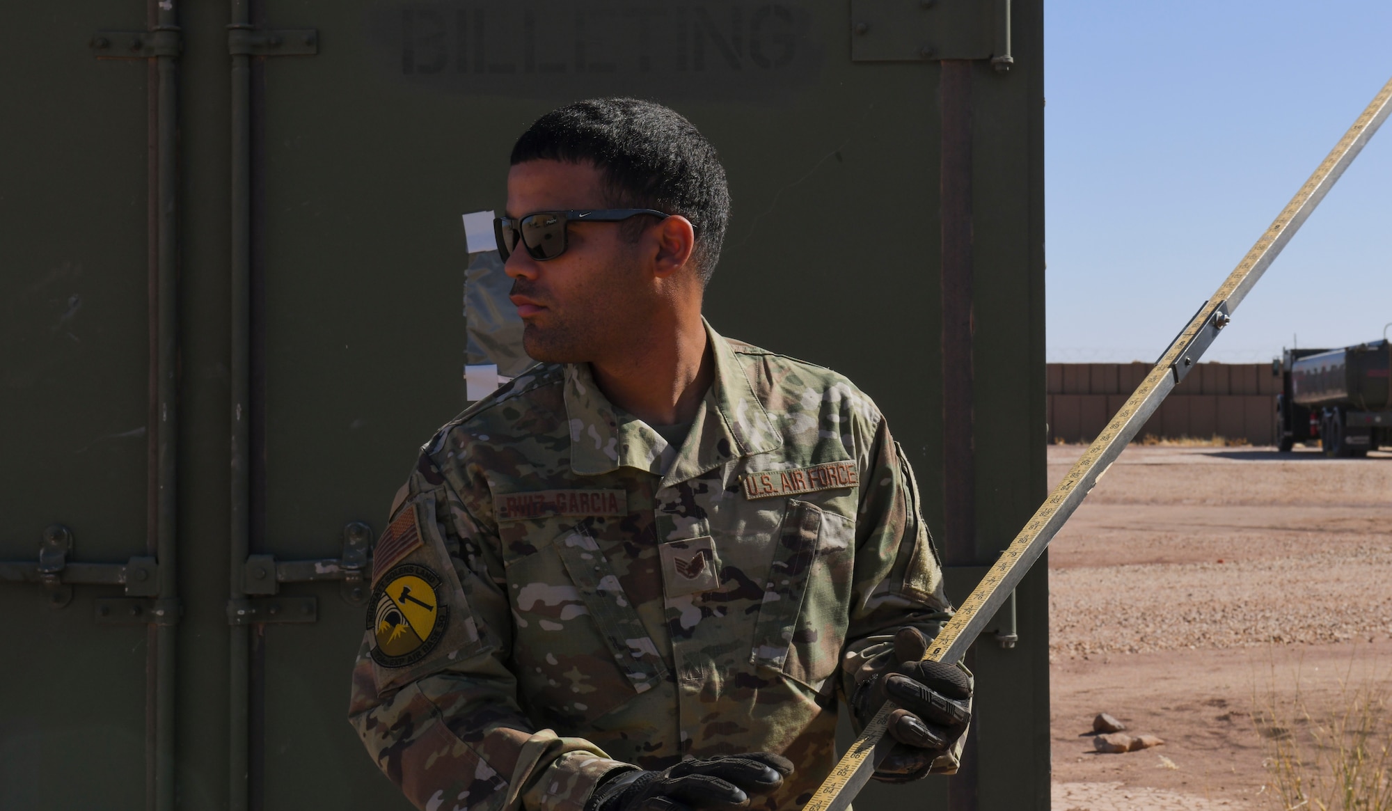 U.S. Air Force Staff Sgt. Josue Ruiz-Garcia, 724th Expeditionary Air Base Squadron fuel operations noncommissioned officer in charge, prepares to measure the volume of fuel with a sticking tank at Nigerien Air Base 201, Agadez, Niger, Feb. 2, 2021. Getting an accurate read on how much volume the tank contains can determine when the petroleum, oil, and lubrication fuels section needs to order more fuel to keep the base stocked. (U.S. Air Force photo by Senior Airman Gabrielle Winn)