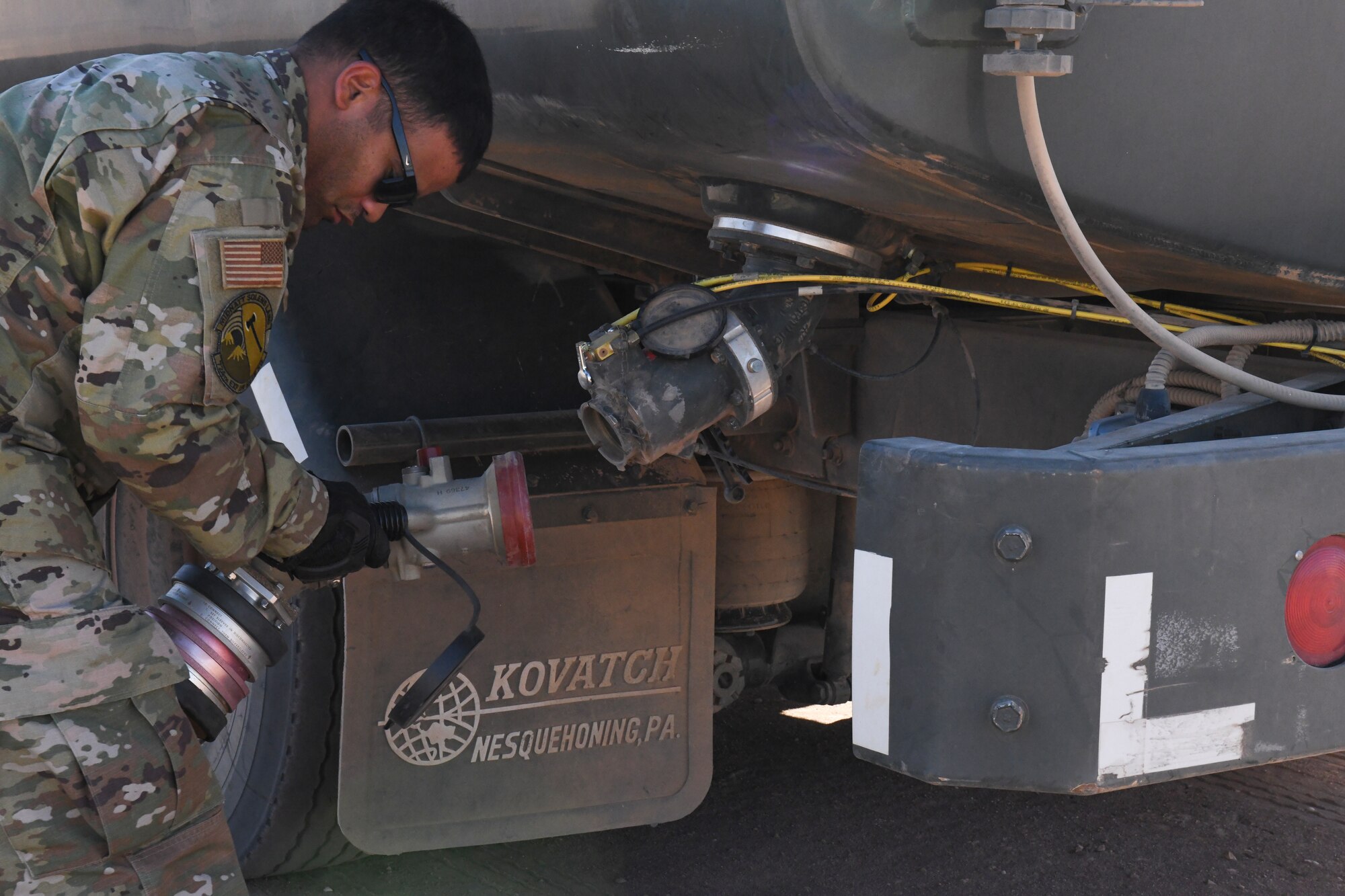 U.S. Air Force Staff Sgt. Josue Ruiz-Garcia, 724th Expeditionary Air Base Squadron fuel operations noncommissioned officer in charge, attaches a fuel pump hose to an R-11 fuels truck at Nigerien Air Base 201, Agadez, Niger, Feb. 2, 2021. The petroleum, oils, and lubrication fuels section is responsible for fueling all vehicles and aircraft at Air Base 201. (U.S. Air Force photo by Senior Airman Gabrielle Winn)